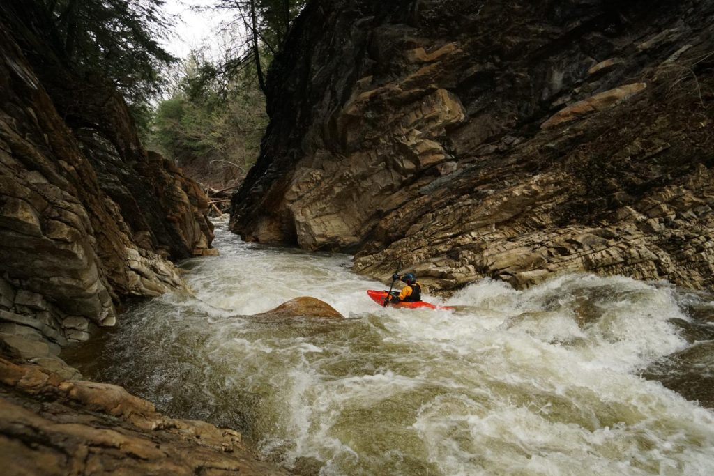Taylor Ratcliffe clearing a hole in the lower gorge Clarendon Gorge Mill River Vermont whitewater kayaking
