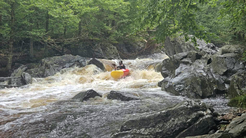 Kayaker descends a drop on the Moose River above Victory Bog Vermont Whitewater Kayaking - photo credit N Lesch-Huie