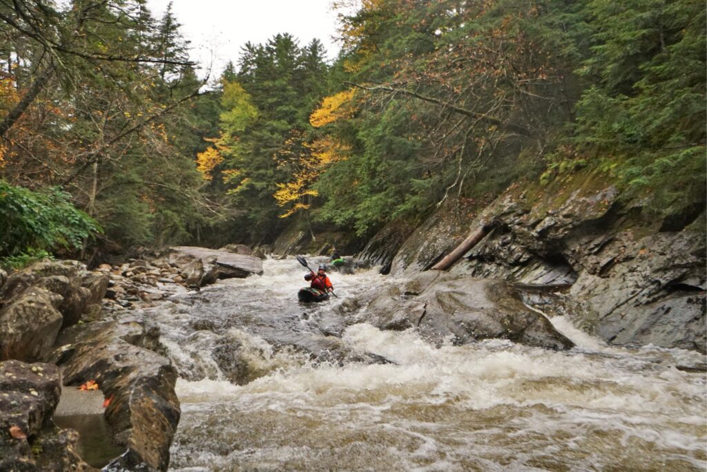 Two kayakers Billy Wagner and Mike Mainer navigate rapids on the Upper New Haven River in South Lincoln Vermont Whitewater Kayaking